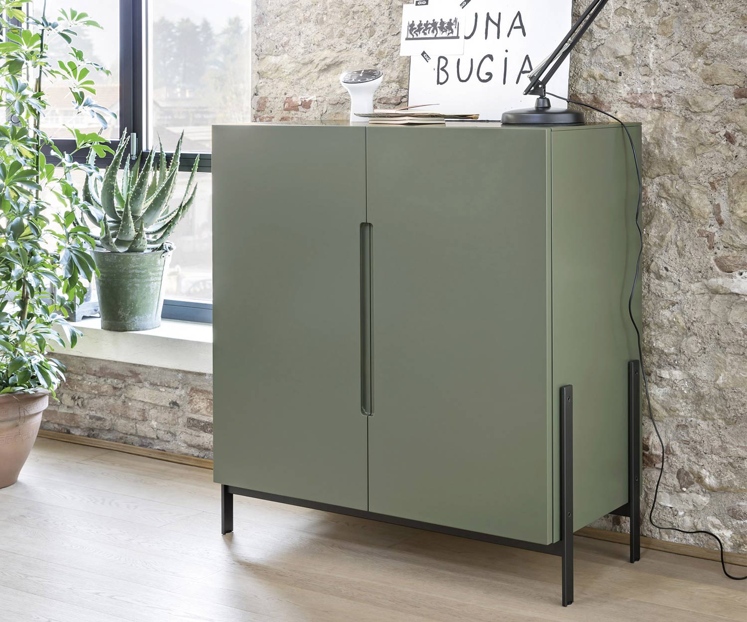 Matt green lacquered Float highboard from Novamobili with narrow legs in the living room
