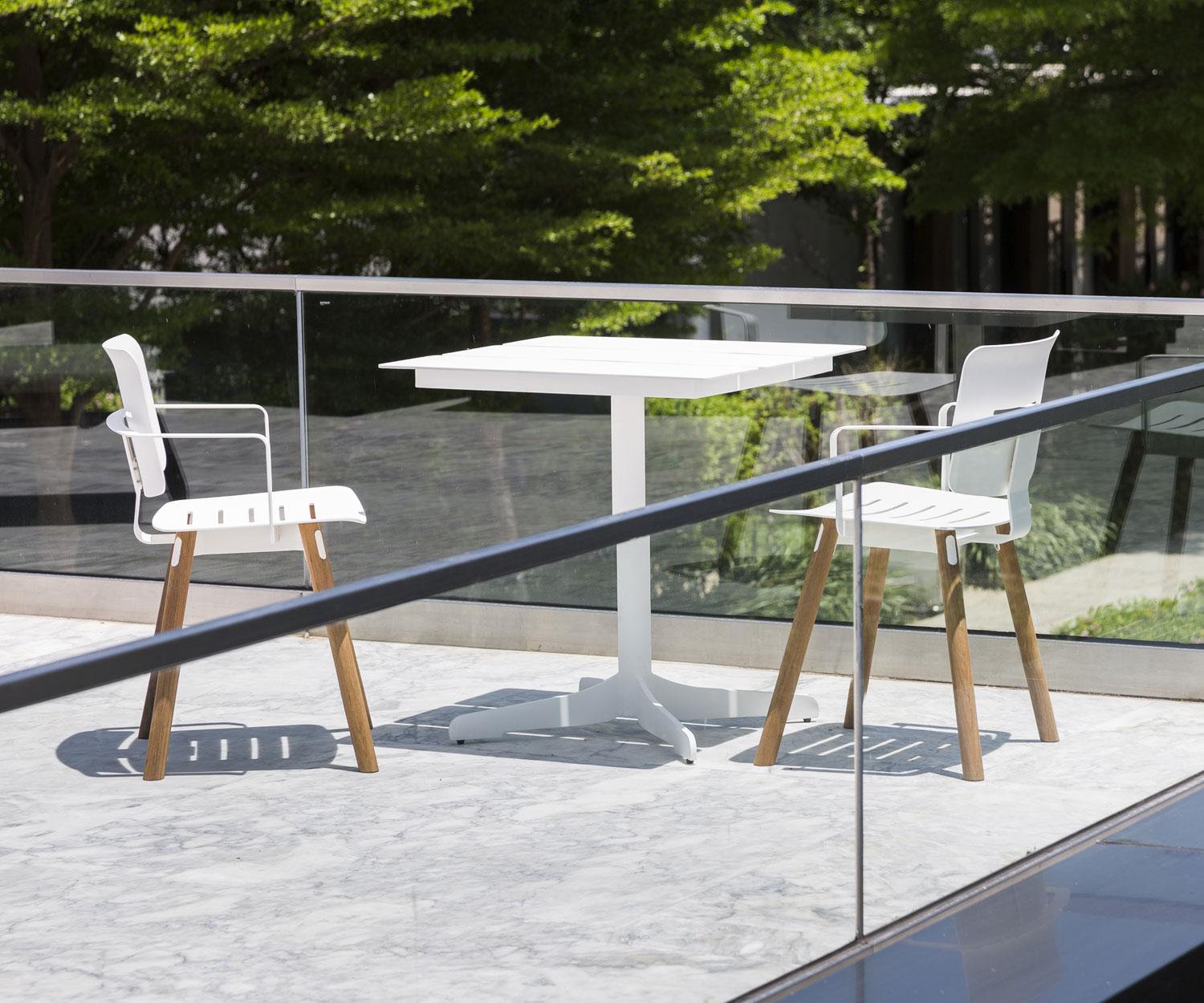 White Oasiq Ceru Design garden table with two garden chairs on terrace